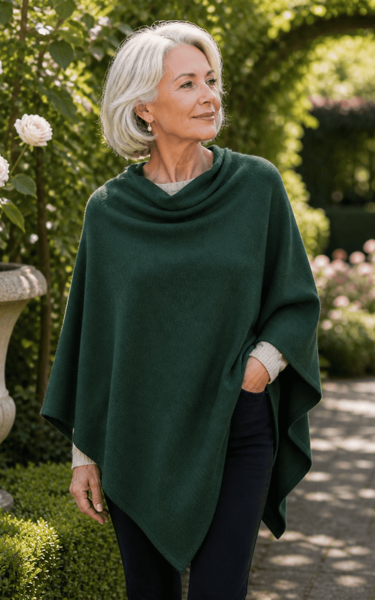 Woman wearing a green poncho in a garden setting