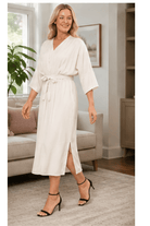 Front Long silk cream dress with mid thigh length and slight slitto knee feature