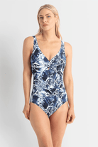 Woman wearing a blue patterned swimsuit on a white background