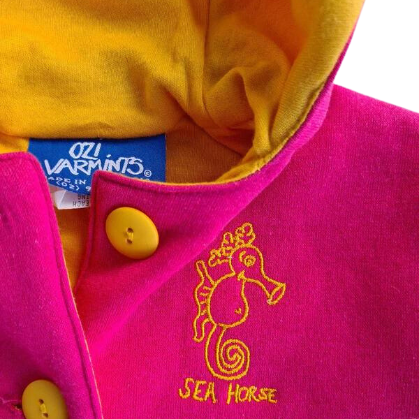 ozi varmints pink/yellow polar fleece reversible hooded jacket with ears and a seahorse design print, close-up view 
